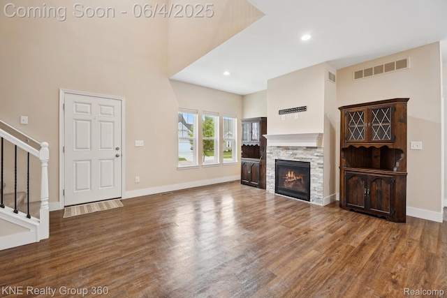 1720 Carlisle St, Howell, MI 48855 - unfurnished living room with stairway, wood finished floors, a fireplace, baseboards, and recessed lighting