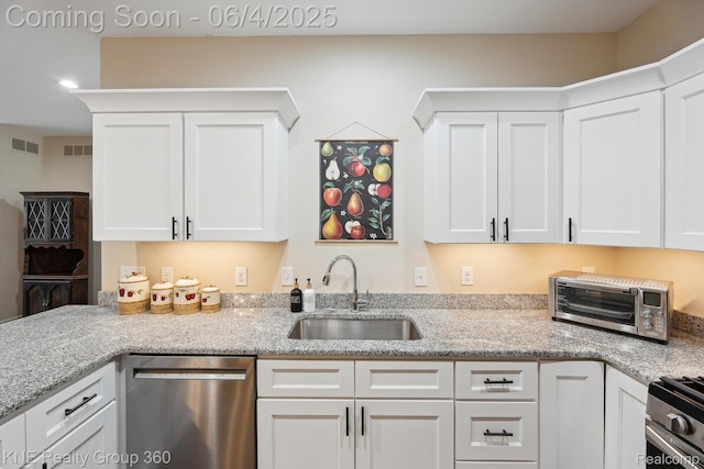 1720 Carlisle St, Howell, MI 48855 - kitchen featuring stainless steel appliances, a sink, and white cabinetry