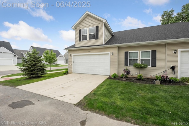 1720 Carlisle St, Howell, MI 48855 - view of front facade featuring a front lawn, driveway, and an attached garage