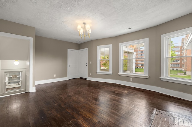 1174 Taylor St, Detroit, MI 48202 - unfurnished living room with dark wood finished floors, a chandelier, baseboards, and a textured ceiling