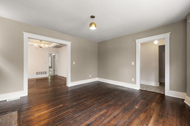 1174 Taylor St, Detroit, MI 48202 - empty room featuring dark wood finished floors, a chandelier, and baseboards