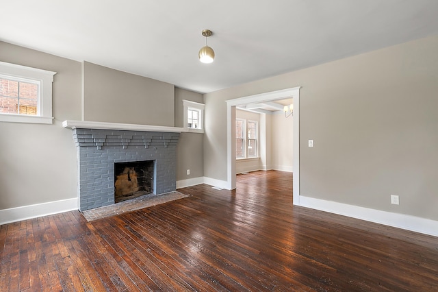 1174 Taylor St, Detroit, MI 48202 - unfurnished living room with hardwood / wood-style flooring, a brick fireplace, and baseboards