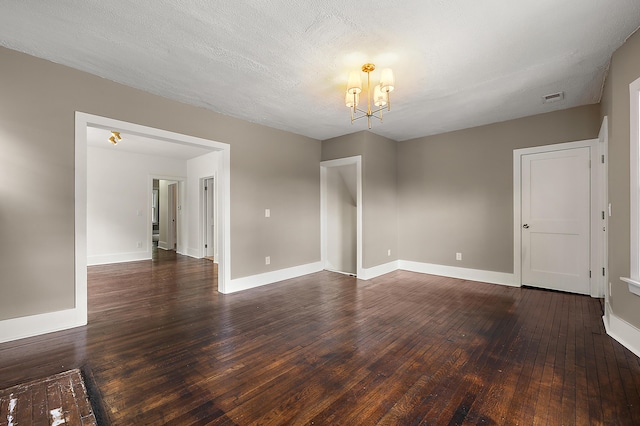 1174 Taylor St, Detroit, MI 48202 - empty room with a chandelier, dark wood-style flooring, and baseboards