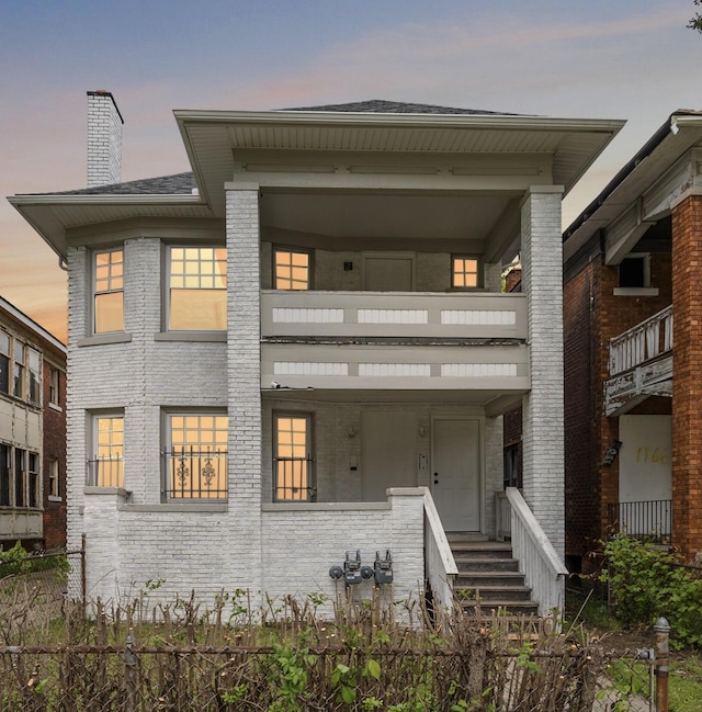 1174 Taylor St, Detroit, MI 48202 - view of front of home with brick siding, a chimney, and a balcony