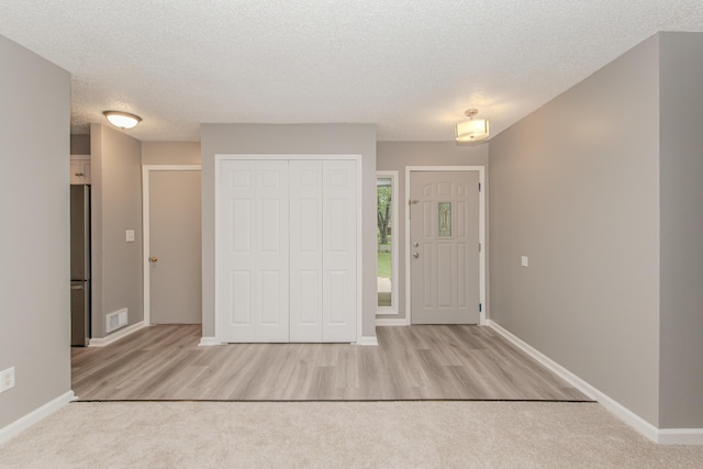242 S Wallace Blvd, Ypsilanti, MI 48197 - foyer entrance featuring a textured ceiling, wood finished floors, and baseboards