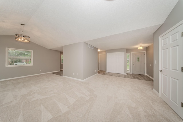 242 S Wallace Blvd, Ypsilanti, MI 48197 - spare room featuring light colored carpet, baseboards, and vaulted ceiling