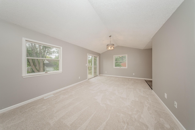 242 S Wallace Blvd, Ypsilanti, MI 48197 - empty room with light colored carpet, lofted ceiling, a textured ceiling, a chandelier, and baseboards