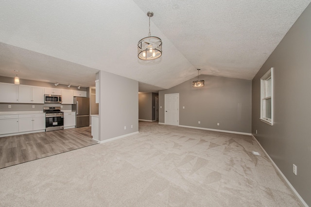 242 S Wallace Blvd, Ypsilanti, MI 48197 - unfurnished living room featuring light colored carpet, a textured ceiling, baseboards, vaulted ceiling, and a chandelier