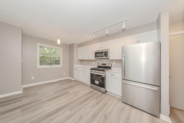 242 S Wallace Blvd, Ypsilanti, MI 48197 - kitchen featuring stainless steel appliances, white cabinets, light wood finished floors, light countertops, and a textured ceiling