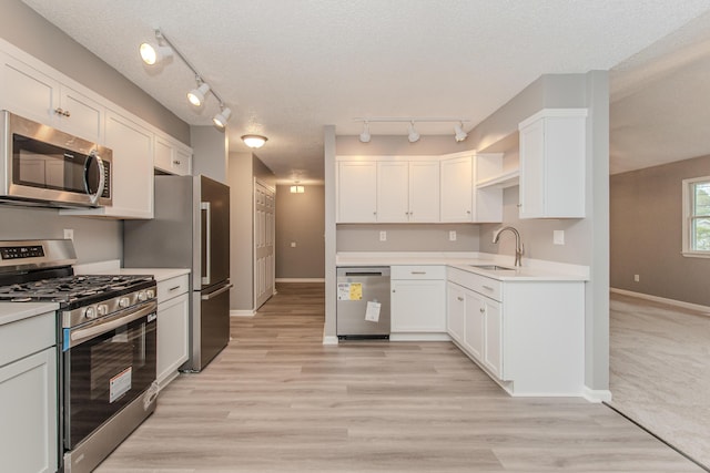 242 S Wallace Blvd, Ypsilanti, MI 48197 - kitchen featuring appliances with stainless steel finishes, a sink, baseboards, white cabinets, and a textured ceiling