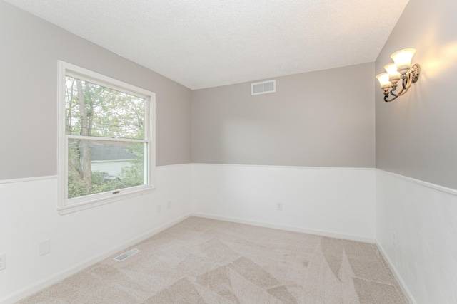 242 S Wallace Blvd, Ypsilanti, MI 48197 - spare room with light carpet, a textured ceiling, and baseboards