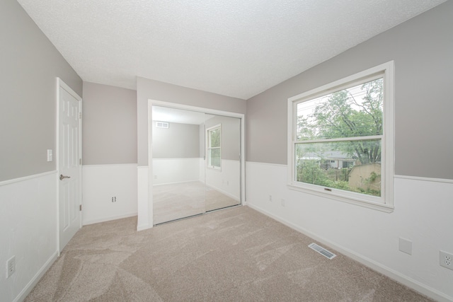 242 S Wallace Blvd, Ypsilanti, MI 48197 - unfurnished bedroom with a textured ceiling and carpet