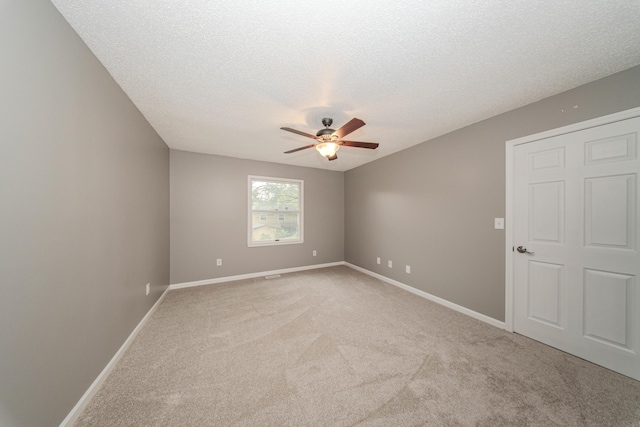 242 S Wallace Blvd, Ypsilanti, MI 48197 - empty room with ceiling fan, light carpet, a textured ceiling, and baseboards