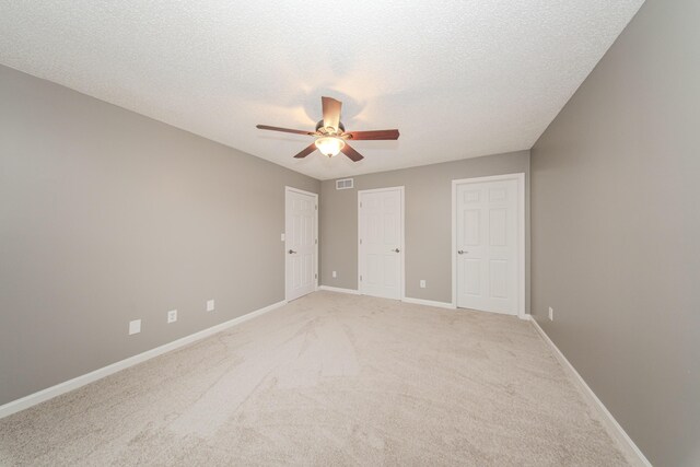 242 S Wallace Blvd, Ypsilanti, MI 48197 - unfurnished bedroom featuring light colored carpet, baseboards, a textured ceiling, and ceiling fan