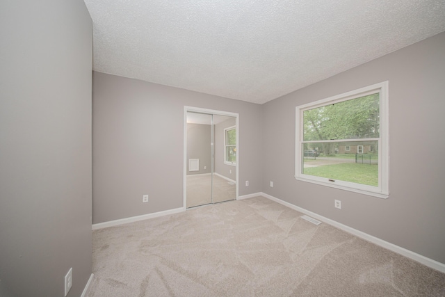 242 S Wallace Blvd, Ypsilanti, MI 48197 - unfurnished bedroom with carpet floors, a textured ceiling, and baseboards