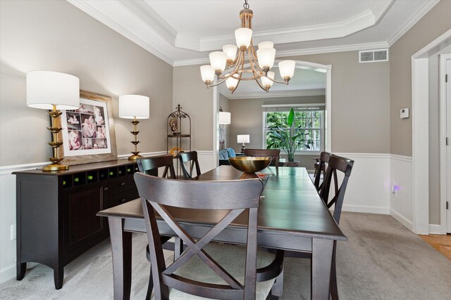 71438 Forest Eagle Ln, Niles, MI 49120 - dining room featuring a chandelier, crown molding, light carpet, a tray ceiling, and baseboards