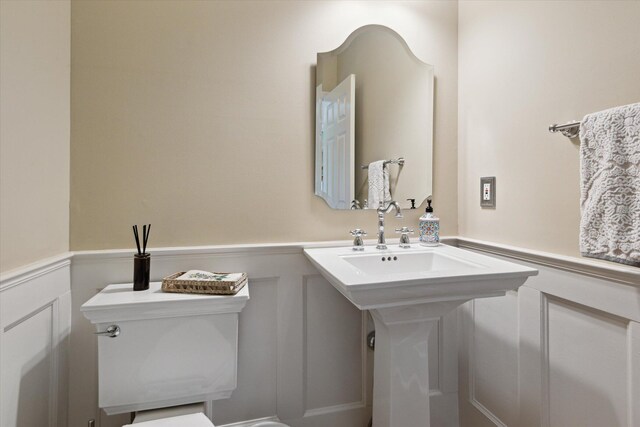 71438 Forest Eagle Ln, Niles, MI 49120 - half bathroom with a wainscoted wall, toilet, and a decorative wall