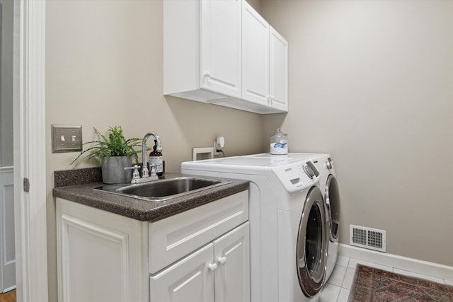 71438 Forest Eagle Ln, Niles, MI 49120 - laundry area featuring washer and clothes dryer, cabinet space, tile patterned flooring, and baseboards