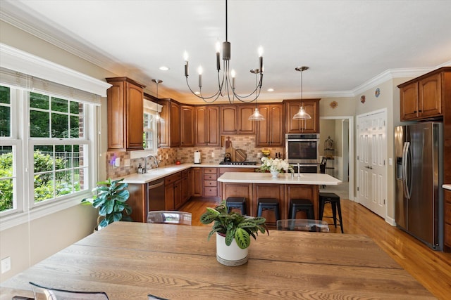 71438 Forest Eagle Ln, Niles, MI 49120 - kitchen featuring stainless steel appliances, a kitchen island, light countertops, a kitchen breakfast bar, and a chandelier