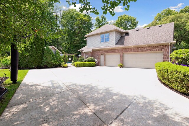 71438 Forest Eagle Ln, Niles, MI 49120 - view of front facade featuring brick siding, driveway, and roof with shingles