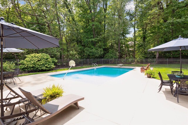 71438 Forest Eagle Ln, Niles, MI 49120 - view of swimming pool featuring a patio area, view of scattered trees, and outdoor dining space