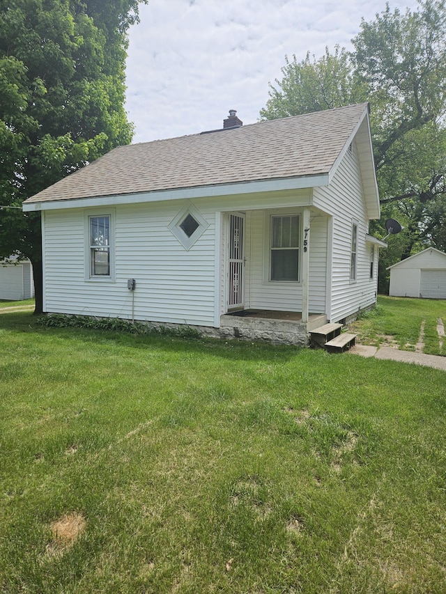 2759 Riverside Rd, Benton Harbor, MI 49022 - view of front facade with a porch, a front yard, and a shingled roof