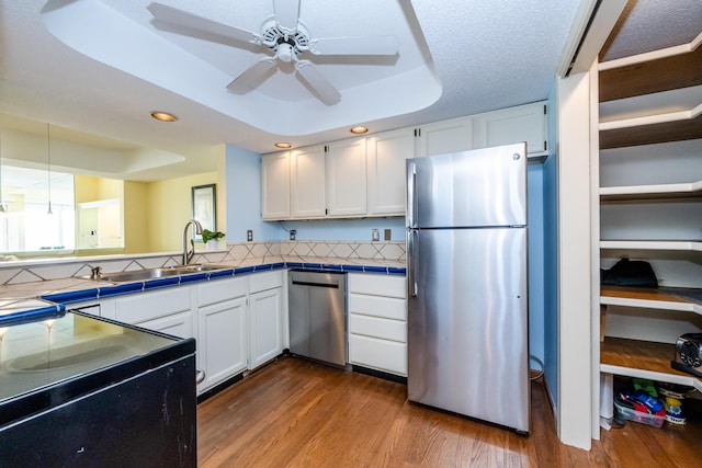 193 Wayne St, Saint Joseph, MI 49085 - kitchen with appliances with stainless steel finishes, tile countertops, recessed lighting, white cabinets, and dark wood-style flooring