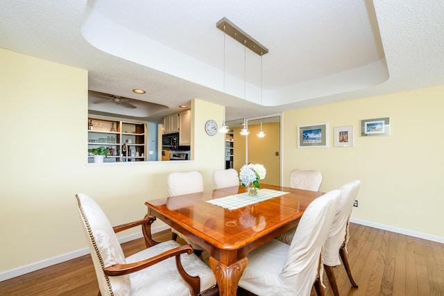 193 Wayne St, Saint Joseph, MI 49085 - dining room with a raised ceiling, baseboards, and light wood-style flooring
