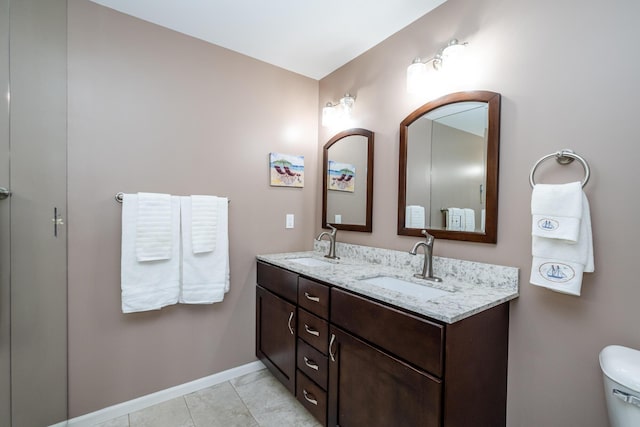 193 Wayne St, Saint Joseph, MI 49085 - full bathroom featuring double vanity, baseboards, and toilet