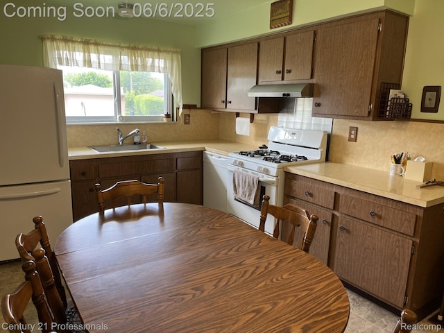 3028 Earl Dr, Warren, MI 48092 - kitchen featuring white appliances, a sink, under cabinet range hood, and light countertops