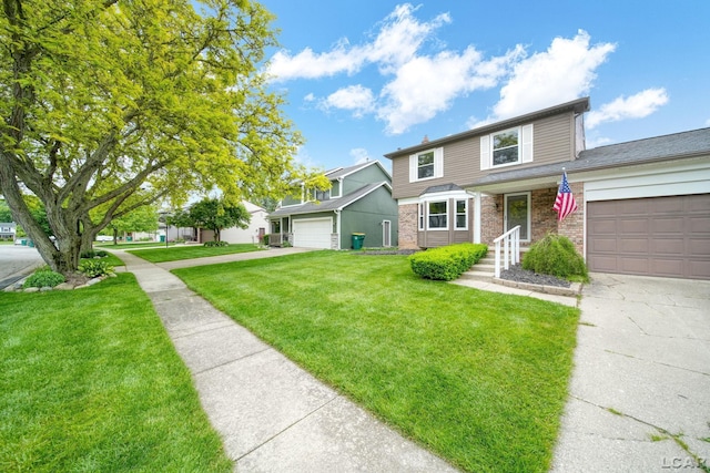 5662 Caren Dr, Ypsilanti, MI 48197 - traditional-style house with a garage, a front lawn, brick siding, and concrete driveway