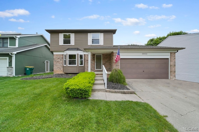 5662 Caren Dr, Ypsilanti, MI 48197 - traditional-style home featuring a garage, a front lawn, driveway, and brick siding