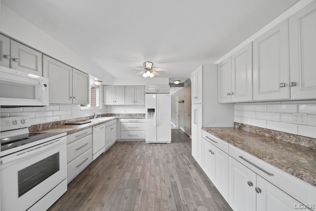 5662 Caren Dr, Ypsilanti, MI 48197 - kitchen with white appliances, tasteful backsplash, ceiling fan, dark wood-style flooring, and a sink