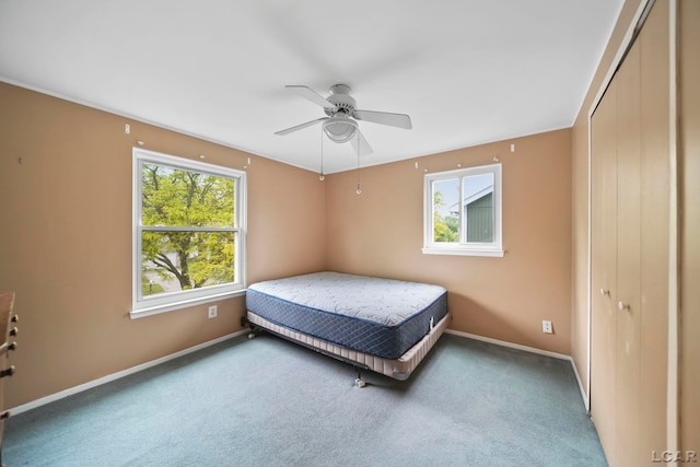 5662 Caren Dr, Ypsilanti, MI 48197 - carpeted bedroom with multiple windows, baseboards, and a closet