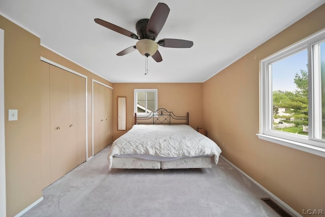 5662 Caren Dr, Ypsilanti, MI 48197 - bedroom featuring multiple closets, carpet floors, ceiling fan, and baseboards