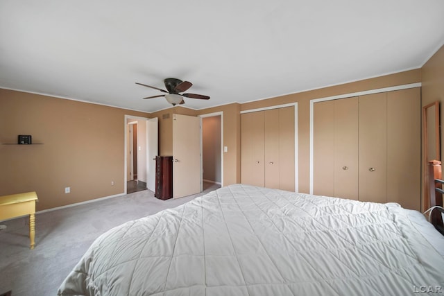 5662 Caren Dr, Ypsilanti, MI 48197 - carpeted bedroom featuring two closets, baseboards, and a ceiling fan