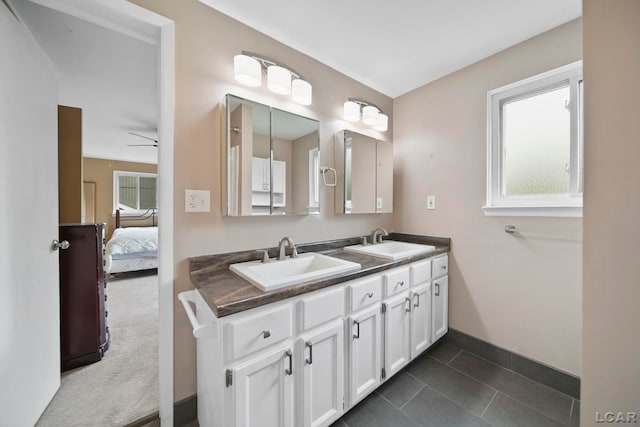 5662 Caren Dr, Ypsilanti, MI 48197 - ensuite bathroom featuring double vanity, baseboards, and tile patterned floors