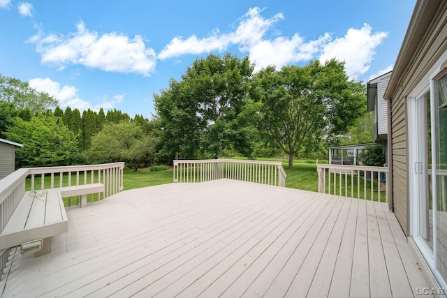 5662 Caren Dr, Ypsilanti, MI 48197 - wooden deck featuring a yard and a sunroom