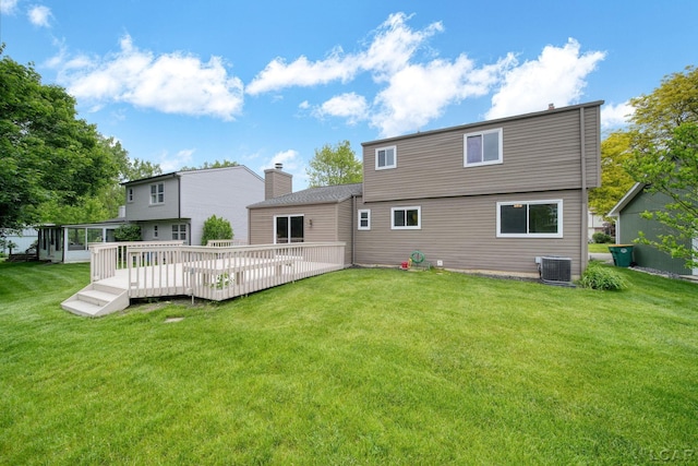 5662 Caren Dr, Ypsilanti, MI 48197 - rear view of house featuring a lawn, central air condition unit, a wooden deck, and a sunroom