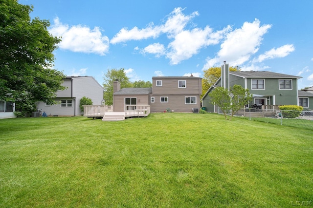 5662 Caren Dr, Ypsilanti, MI 48197 - back of house with a chimney, a wooden deck, and cooling unit