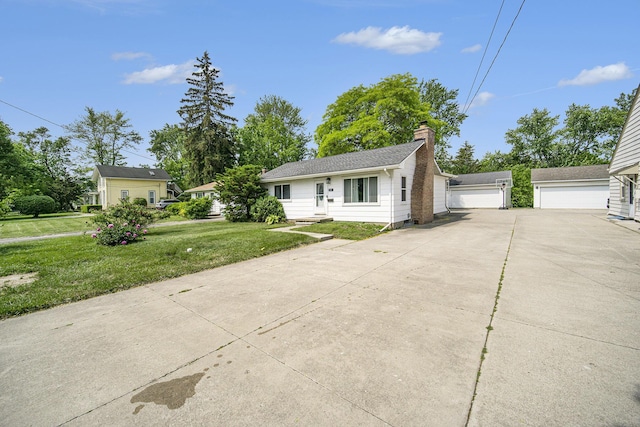 111 N Maple Rd, Saline, MI 48176 - view of front of house featuring a chimney, a front lawn, and a garage