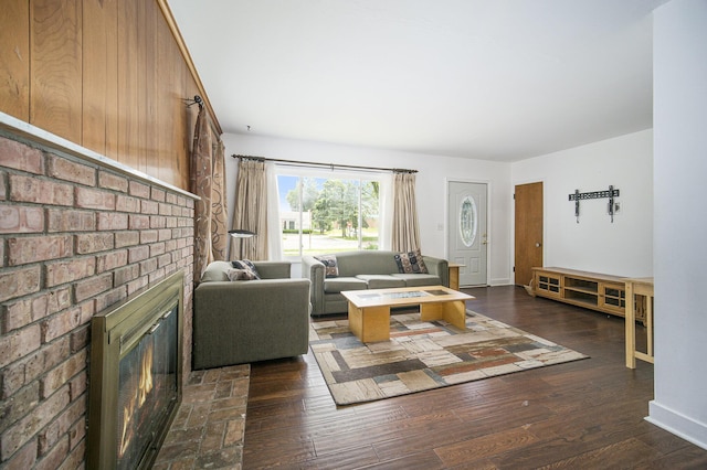 111 N Maple Rd, Saline, MI 48176 - living room featuring a fireplace, dark wood-type flooring, and baseboards