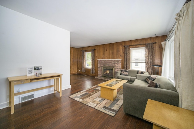 111 N Maple Rd, Saline, MI 48176 - living area featuring wooden walls, hardwood / wood-style flooring, baseboards, and a brick fireplace