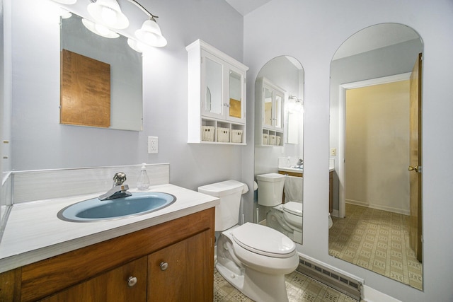111 N Maple Rd, Saline, MI 48176 - bathroom with toilet, vanity, and a baseboard radiator