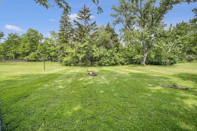 111 N Maple Rd, Saline, MI 48176 - view of grassy yard featuring an outdoor fire pit