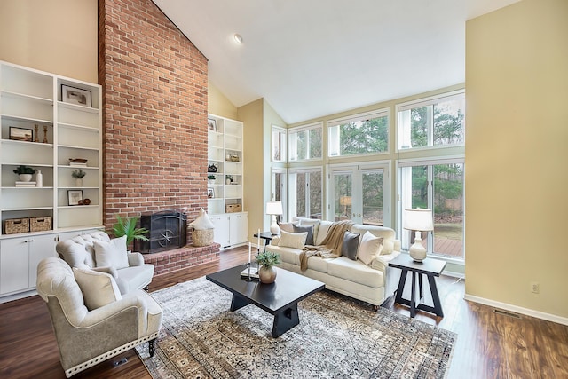 3329 Craig Rd, Ann Arbor, MI 48103 - living area with high vaulted ceiling, dark wood-type flooring, baseboards, built in shelves, and a fireplace