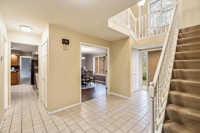 3329 Craig Rd, Ann Arbor, MI 48103 - entrance foyer with light tile patterned flooring, stairs, and baseboards