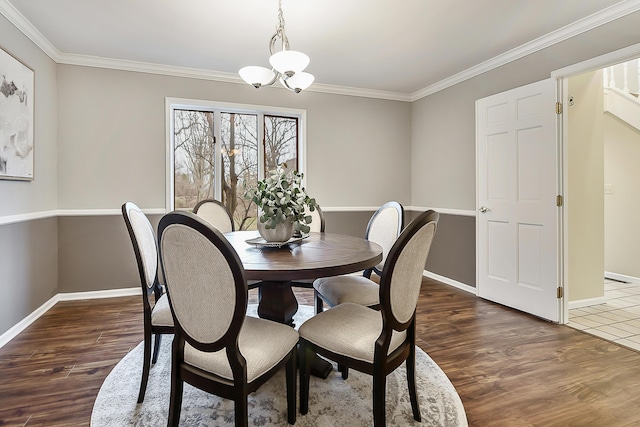 3329 Craig Rd, Ann Arbor, MI 48103 - dining room featuring baseboards, wood finished floors, crown molding, and a chandelier
