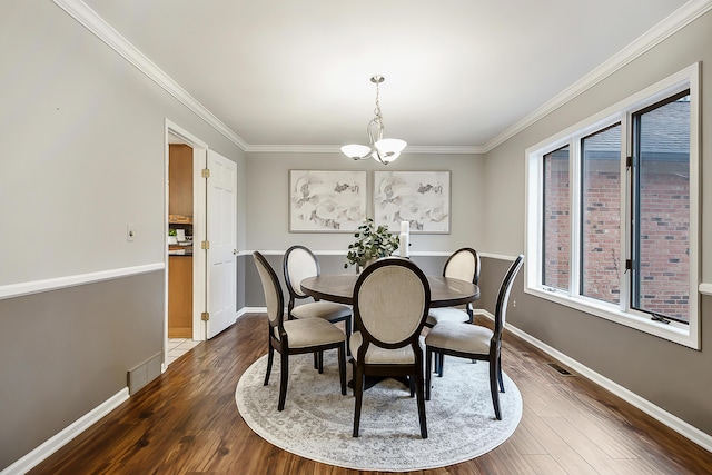 3329 Craig Rd, Ann Arbor, MI 48103 - dining area featuring a chandelier, dark wood-style flooring, crown molding, and baseboards