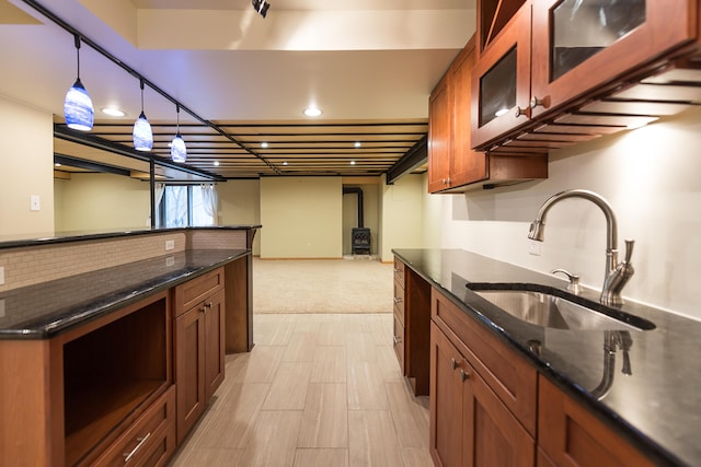3329 Craig Rd, Ann Arbor, MI 48103 - kitchen with a sink, dark stone countertops, glass insert cabinets, pendant lighting, and recessed lighting